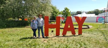 Posing in Front of the Hay Sign